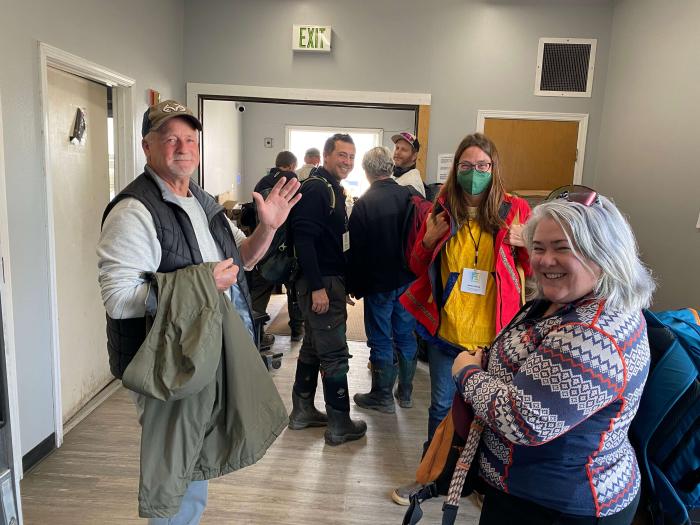 Figure 3. Bill Tracey Sr. of Point Lay (left) departs with seven other participants, including Colleen Strawhacker of the National Science Foundation (far right) and Jessica Garron (second from right) of UAF's  International Arctic Research Center, on a day trip to tour his home community, which has been called Ground Zero for climate change on the North Slope. A second group flew to Wainwright with Eddie and Jimmy Kagak. Wright Air provided charter service for the Symposium. Photo courtesy of Jana Peirce.